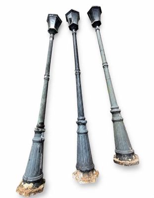 three old fashioned street lights are shown against a white background