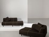 a couch and ottoman in a room with a white floor
