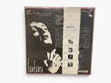 an old album with a picture of a man in a suit and tie
