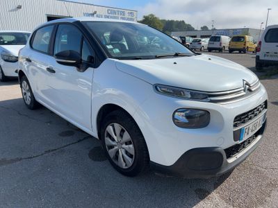 a white citrole is parked in a parking lot