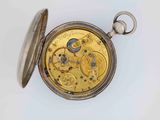 an antique pocket watch with a gold dial on a white surface