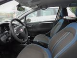 the interior of a small car with blue trims and a steering wheel