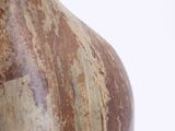a vase that has a brown and white design on it