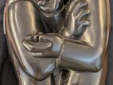 a statue of a man and a woman hugging each other