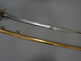 two swords and a sword on a table with a clock in the background