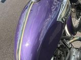 a purple motorcycle parked on the side of the road