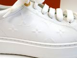 a close up of a pair of white shoes on a table