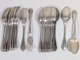 a lot of silver spoons and spoons on the table