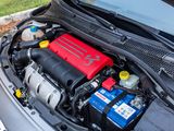 a car engine with a red battery in the hood