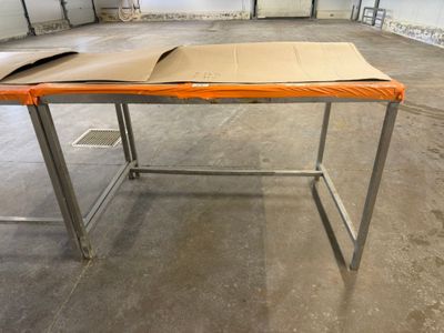 a table with a cardboard box on it in a warehouse