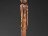 a wooden statue of a man with a hat on his head