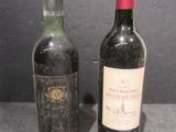 two bottles of wine sitting next to each other on a table