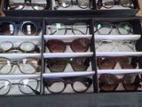 many pairs of glasses in a case on the floor