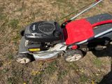 a lawn mower that is sitting in the grass