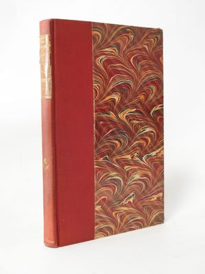 a book with a red cover sitting on top of a white surface
