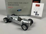 an old model of a silver race car sitting next to a boxed box