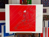 a picture of a red and white painting on a easel