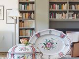 two plates and a bowl on a table in a living room