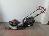 an image of a lawn mower parked in a garage