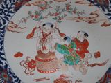 a plate with a painting on it on a table