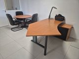an image of a desk and chairs in a room