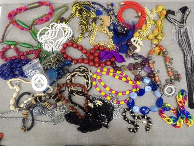 a lot of different necklaces and bracelets on a table