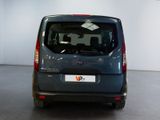 a small grey van parked in a large room