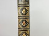 six books stacked on top of each other on a white surface