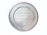 a silver plate that has a picture of a person on it
