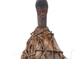 an old wooden figurine with a rope wrapped around it ' s neck