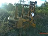 a yellow bulldozer sitting in the middle of a field