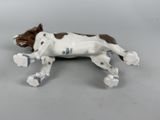 a figurine of a dog that is laying down