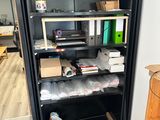a black bookcase with lots of boxes on top of it