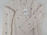 the sweater is white and has blue buttons on it