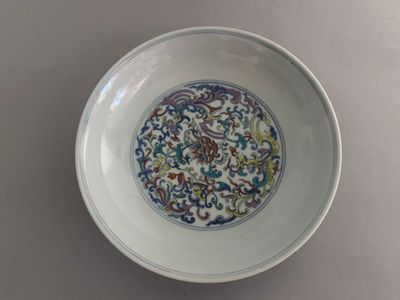 a white bowl with a blue and green design on it