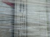 a picture of a man standing in a room wrapped in plastic