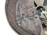 a close up of a brown leather shoe with laces on it