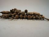a pile of wooden pegs sitting on a white surface