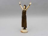 an image of a statue of a woman holding her hands up