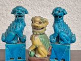 three figurines of foo foo foo sitting on a table