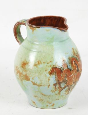PICHET en terre cuite vernissée à décor de cavaliers sur fon…
