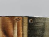 a close up of a metal object with a painting on it