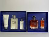 a couple of bottles of perfume sitting on top of a blue box