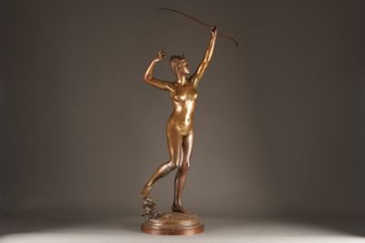 bronze statue of a woman holding a golf club on a marble base