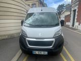 the van is parked on the side of the road in front of a building