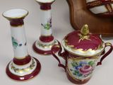three vases and a teapot sitting on a table