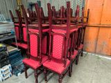 a lot of red chairs that are sitting in a room