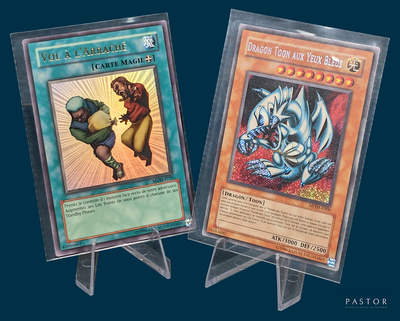 two pokemon cards on display on a blue background
