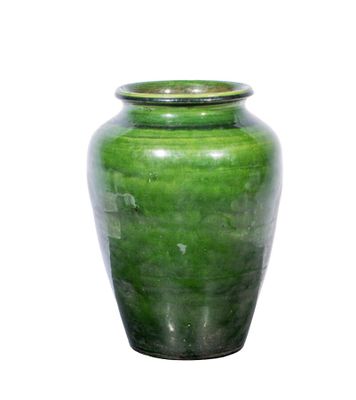 a green vase that is sitting on a white surface