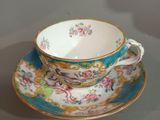 a tea cup and saucer sitting on a table